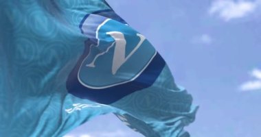 Naples, Italy, July 2022: The flag of SSC Napoli waving. SSC Napoli is a professional football club based in Naples, Italy. Seamless loop in slow motion. Selective focus. Rear view