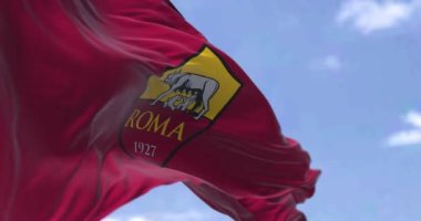 Rome, Italy, July 2022: Rear view of the AS Roma flag waving on a clear day. AS Roma is a professional football club based in Rome. Seamless loop in slow motion. Selective focus
