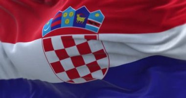 Close-up view of the Croatian national flag waving in the wind. Croatia is a country located in Southeast Europe. Fabric textured background. Selective focus. Seamless loop in slow motion