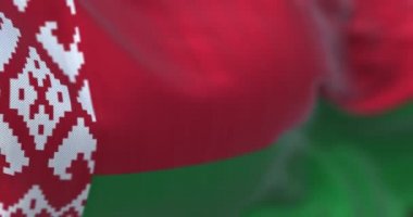 Close-up view of the Belarus national flag waving in the wind. Fabric textured background. Selective focus. Seamless loop in slow motion