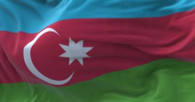 Close-up view of the Azerbaijan national flag waving in the wind. Fabric textured background. Selective focus. Seamless loop in slow motion