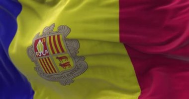 Close-up view of the Andorra national flag waving in the wind. Fabric textured background. Selective focus. Seamless loop in slow motion