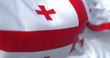 Close-up view of the national flag of Georgia waving in the wind. Selective focus. Fabric textured background. Seamless loop in slow motion