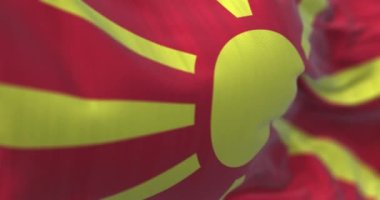 Kuzey Makedonya ulusal bayrağının dalgalanmasına yakından bakın. Kuzey Makedonya Cumhuriyeti, Güneydoğu Avrupa 'da bir ülkedir. Kumaş desenli arka plan. Seçici odaklanma. Yavaş çekimde kusursuz döngü