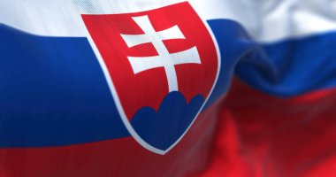 Slovakya ulusal bayrağının rüzgarda dalgalanırken yakın plan görüntüsü. Slovakya Orta Avrupa 'da denize kıyısı olmayan bir ülkedir. Kumaş desenli arka plan. Seçici odak