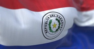 Rüzgarda dalgalanan Paraguay ulusal bayrağının yakın çekim görüntüsü. Paraguay Cumhuriyeti Güney Amerika 'da denize kıyısı olmayan bir ülkedir. Kumaş desenli arka plan. Seçici odaklanma. Yavaş çekimde kusursuz döngü