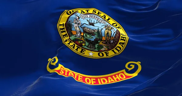 Close-up view of the Idaho state flag waving in the wind. Idaho is a state in the Pacific Northwest region of the United States. Democracy and independence.