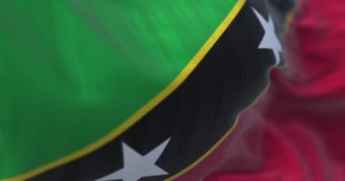 Saint Kitts ve Nevis bayrağı dalgalanırken yakın çekim görüntüsü. Saint Kitts ve Nevis Federasyonu, Orta Amerika 'da bir ada devletidir. Kumaş desenli arka plan. Seçici odaklanma. Yavaş çekimde kusursuz döngü