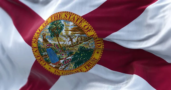 Close-up view of the Florida state flag waving in the wind. Florida is a state of the United States of America. Fabric textured background. Selective focus