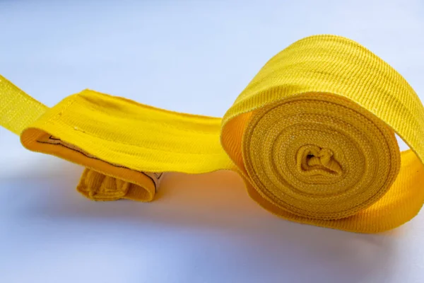 Yellow boxing hand bandage wraps on white background. Sports equipment for boxing. Top view, flat lay, copy space