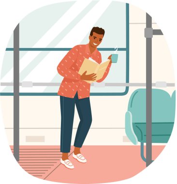 Kitap okuyan genç adam masanın yanında duruyor, evde ders çalışıyor.