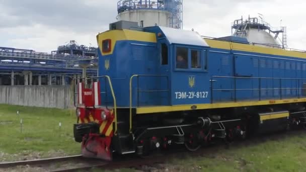 Vista aérea de um trem nos trilhos ao lado dos edifícios de produção, planta química. A câmera voa sobre um trem de pé nos trilhos. — Vídeo de Stock