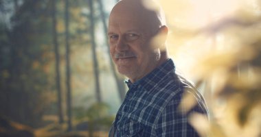 Doğada yalnız yürüyen mutlu bir adam. Rahatlatıcı, sağlıklı bir yaşam tarzı.