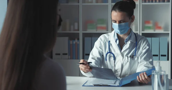 Professional Doctor Meeting Patient Her Office Wearing Protective Surgical Masks — Stock Photo, Image