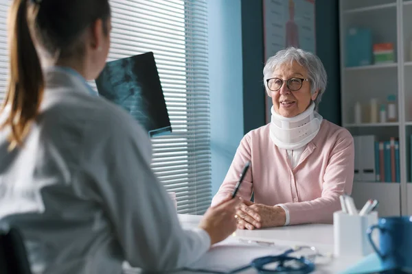 Dokter Zit Aan Het Bureau Controleert Röntgenfoto Van Een Patiënt — Stockfoto