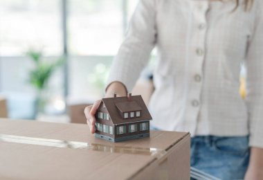 Kadın model ev tutuyor, ev dekorasyonu ve yenileme konsepti.