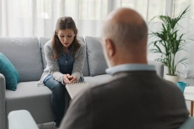 Terapist koltuğunda oturan depresyondaki kadın, akıl sağlığı konsepti.