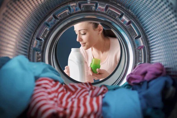 Woman smelling a scented laundry detergent, household chores and products concept, point of view shot