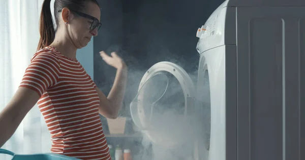Upset Woman Staring Her Broken Washing Machine Room Full Smoke — Stock Photo, Image