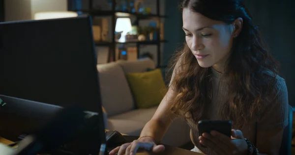 Mujer Joven Conectándose Con Computadora Sosteniendo Teléfono Inteligente —  Fotos de Stock