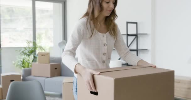 Woman unpacking in her new home — Stock Video