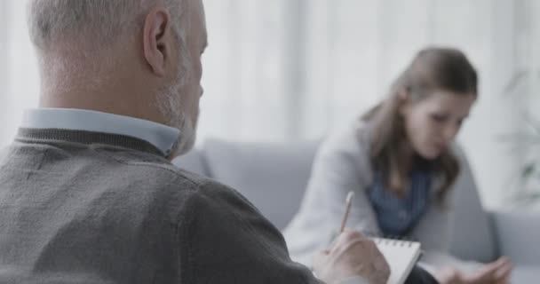 Женщина разговаривает со своим профессиональным терапевтом в офисе — стоковое видео