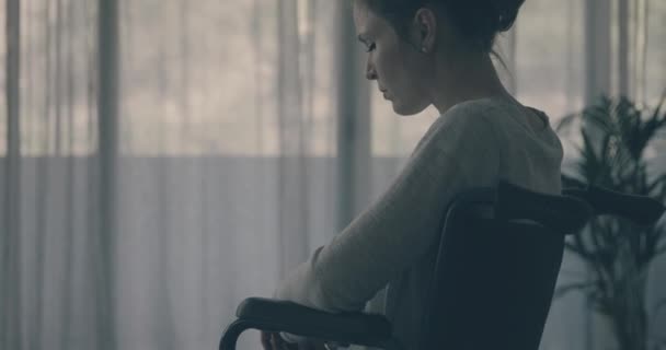 Tekerlekli sandalyedeki üzgün yalnız kadın — Stok video