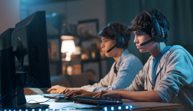 Friends sitting at desk and playing online video games together