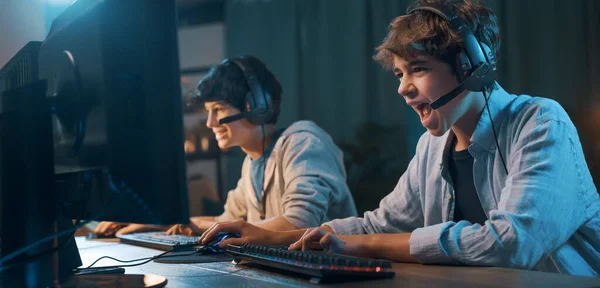 Young Gamers Sitting Desk Playing Online Video Games Together One — Stockfoto