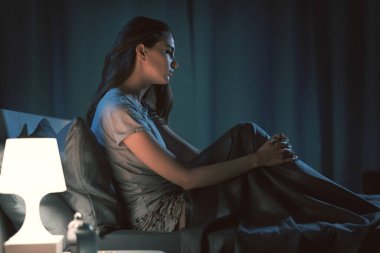 Young sleepless woman in her bedroom, sleep disorder concept