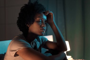 Young stressed woman suffering from insomnia, she can't sleep and she has a headache