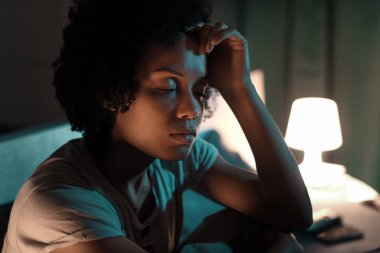 Young stressed woman suffering from insomnia, she can't sleep and she has a headache