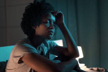 Young stressed woman suffering from insomnia, she can't sleep and she has a headache