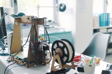 3D printer and tools on the laboratory desk: additive manufacturing, prototyping and engineering concept