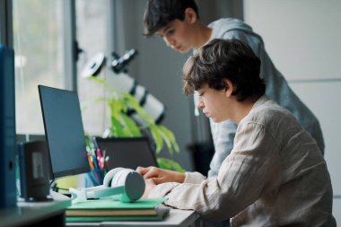 Young students using computers in the lab, learning and technology concept