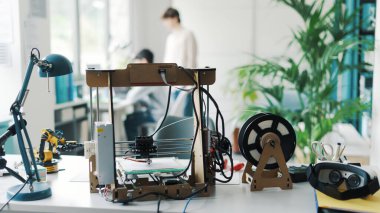 3D printer and tools on the laboratory desk: additive manufacturing, prototyping and engineering concept