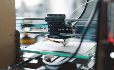 3D printer and tools on the laboratory desk: additive manufacturing, prototyping and engineering concept