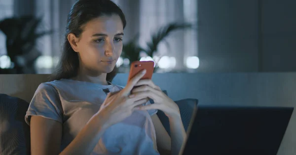 Woman Using Her Smartphone Laptop Home — Stok fotoğraf