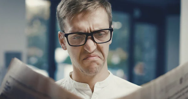 Man Reading Bad News Newspaper Disgusted Disappointed — Stockfoto