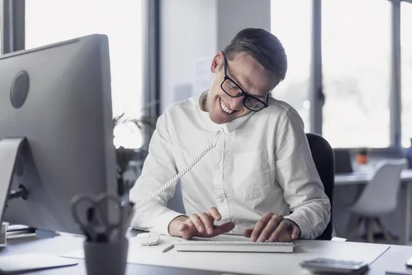 Corporate Businessman Sitting Desk Answering Phone Calls Smiling Typing Computer — Zdjęcie stockowe