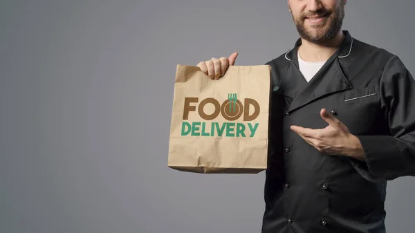 Smiling Chef Showing Bag Ready Meal Take Away Food Concept — Stockfoto