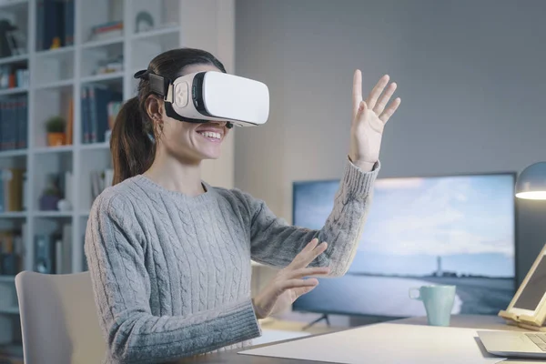 Young Woman Sitting Desk Wearing Headset She Interacting Virtual Reality — Stockfoto