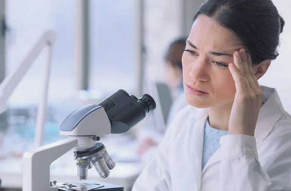 Young Researcher Working Lab Using Microscope She Having Headache — Zdjęcie stockowe