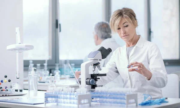 Female Researcher Working Laboratory She Holding Microscope Slide Checking Sample — ストック写真