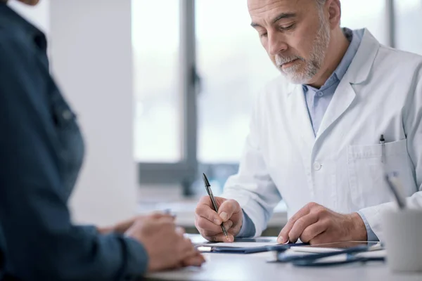 Doctor Sitting Desk His Office Writing Medical Prescription His Patient — Stock Photo, Image