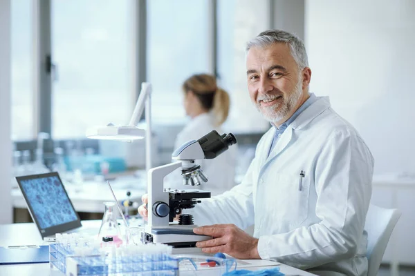 Confident Smiling Researcher Sitting Desk Working Medical Lab — Photo