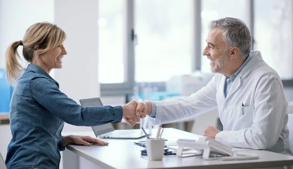 Smiling Patient Doctor Shaking Hands Office —  Fotos de Stock