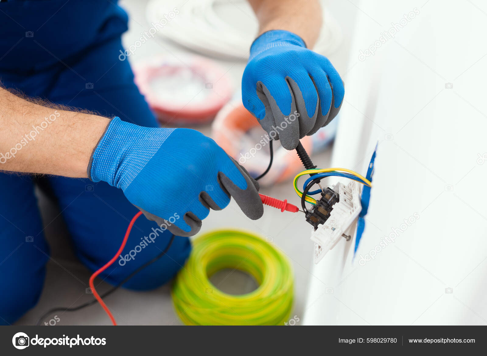 Professional Electrician Testing Outlet Using Digital Multimeter Stock