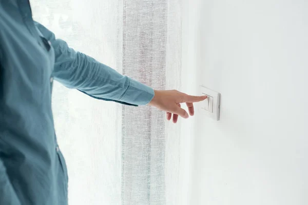 Woman Pressing Light Switch Energy Saving Concept — 스톡 사진