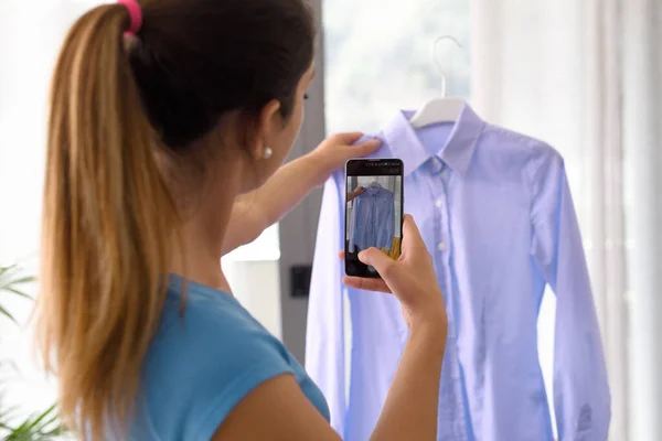 Woman Taking Picture Her Used Shirts Her Smartphone She Selling — Stok fotoğraf